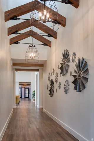 Vaulted ceiling with exposed wood beams and architectural lighting