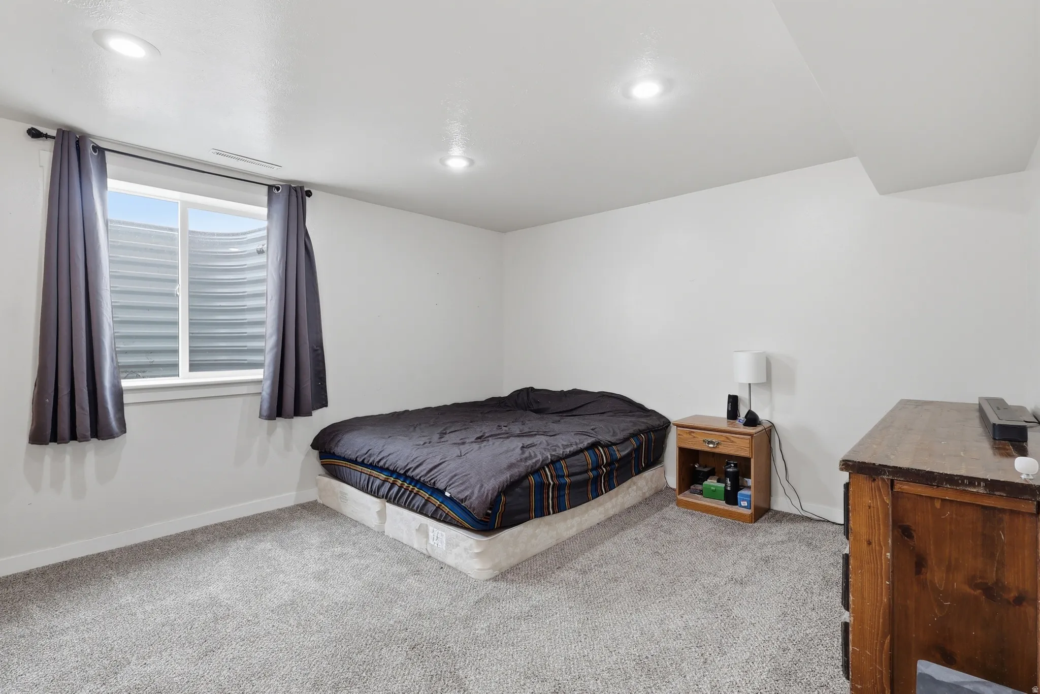 Bedroom featuring light carpet and recessed lighting