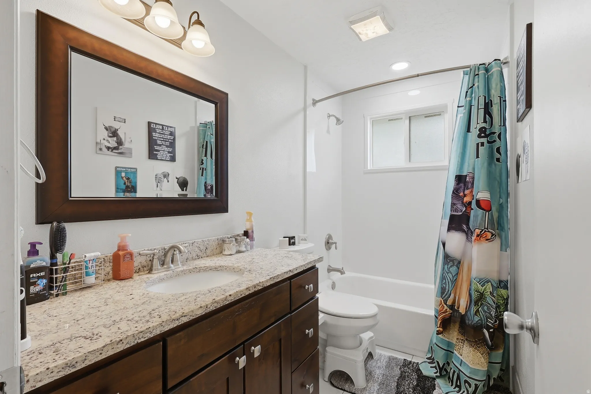 Bathroom featuring vanity and shower / bath combo with shower curtain
