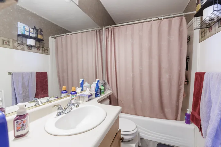 Bathroom with vanity and shower / bath combination with curtain