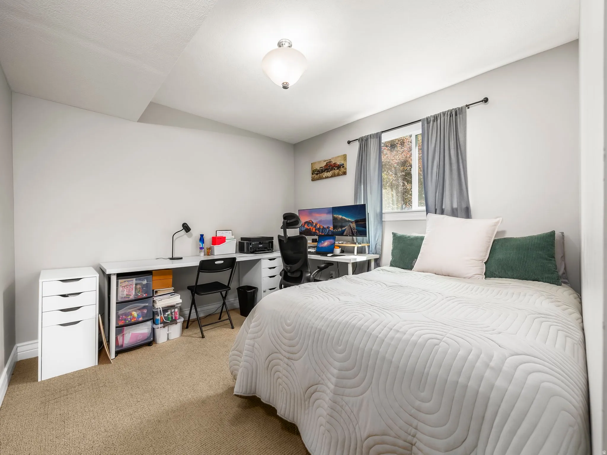 Carpeted bedroom featuring an office area