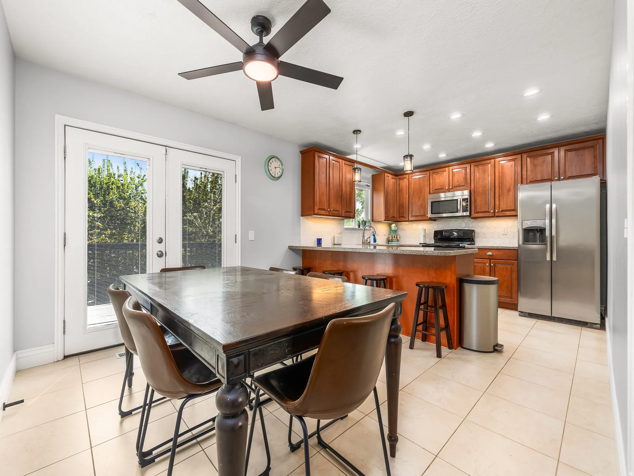 Dining area with recessed lighting, a ceiling fan, light tile patterned floors, and french doors