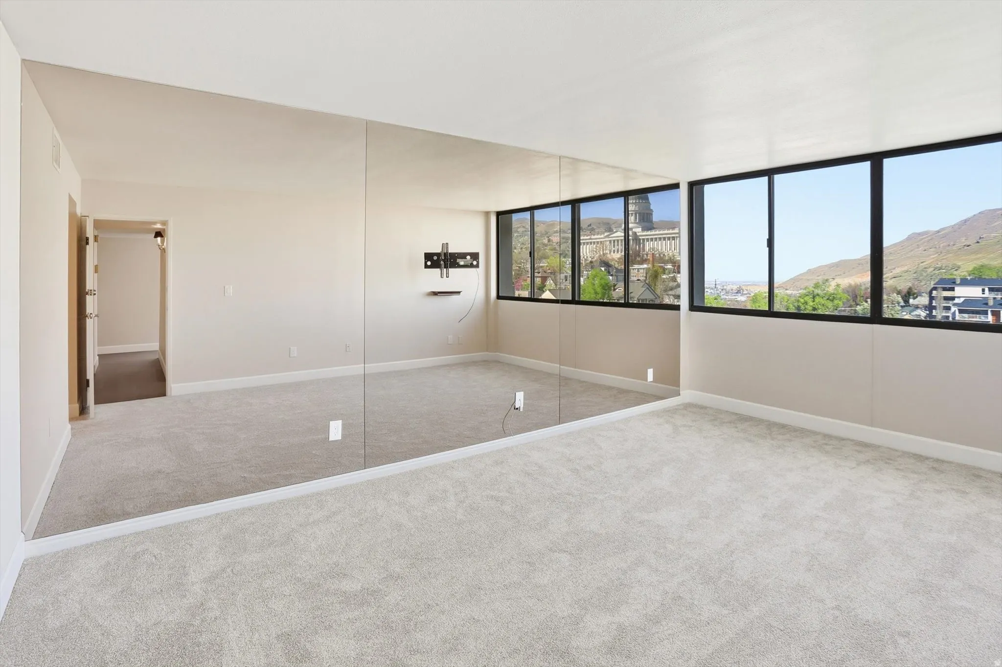 Unfurnished bedroom featuring carpet flooring and a mountain view