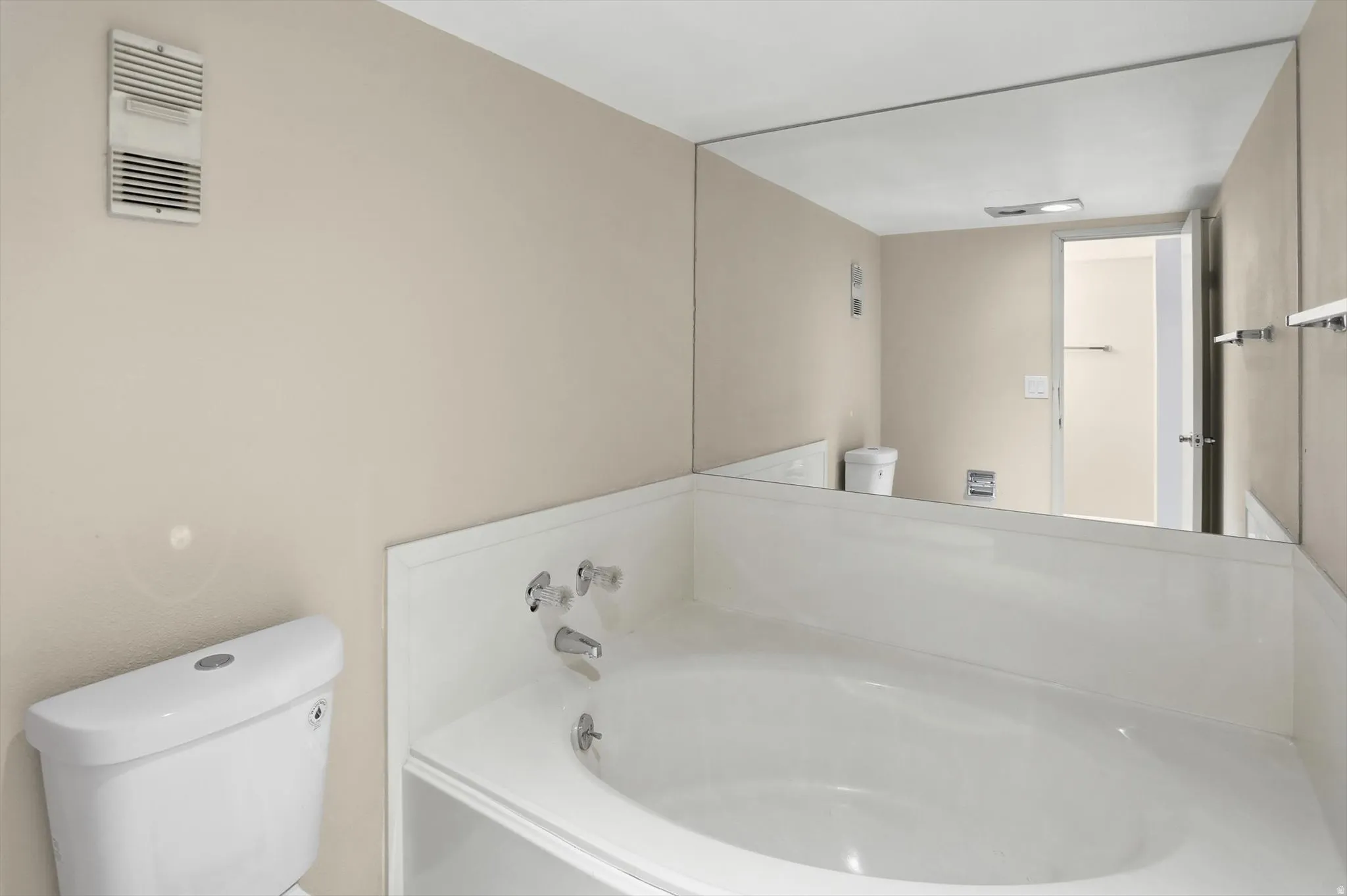 Full bath with toilet and a garden tub