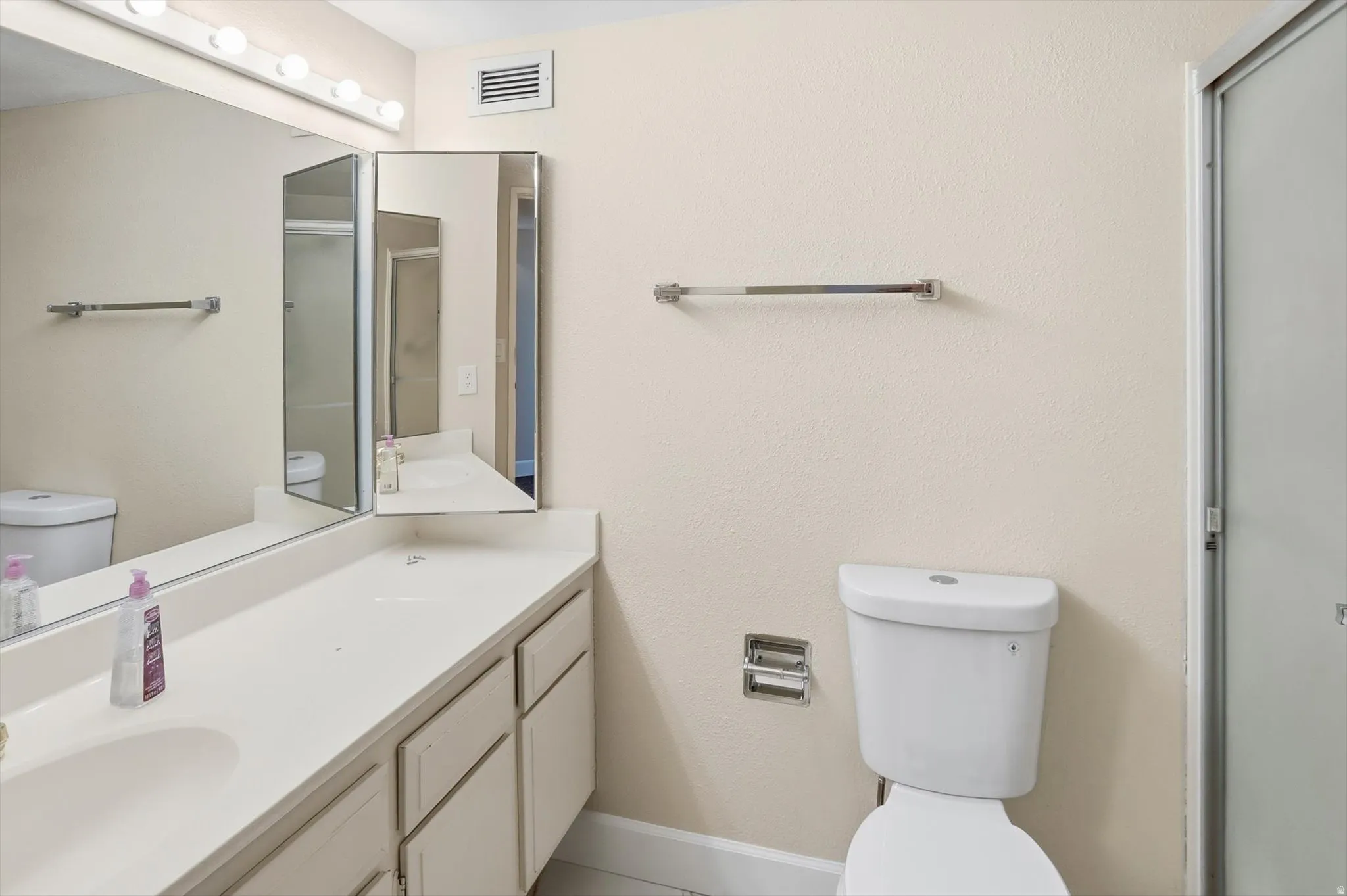 Bathroom with vanity and a shower with shower door