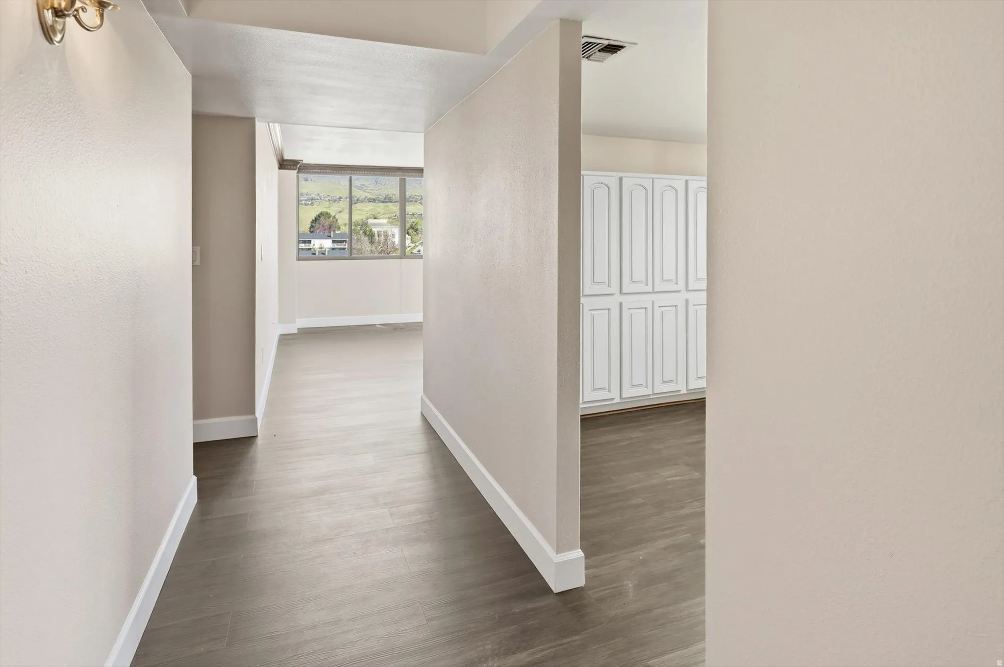 Hall with baseboards and dark wood-style flooring