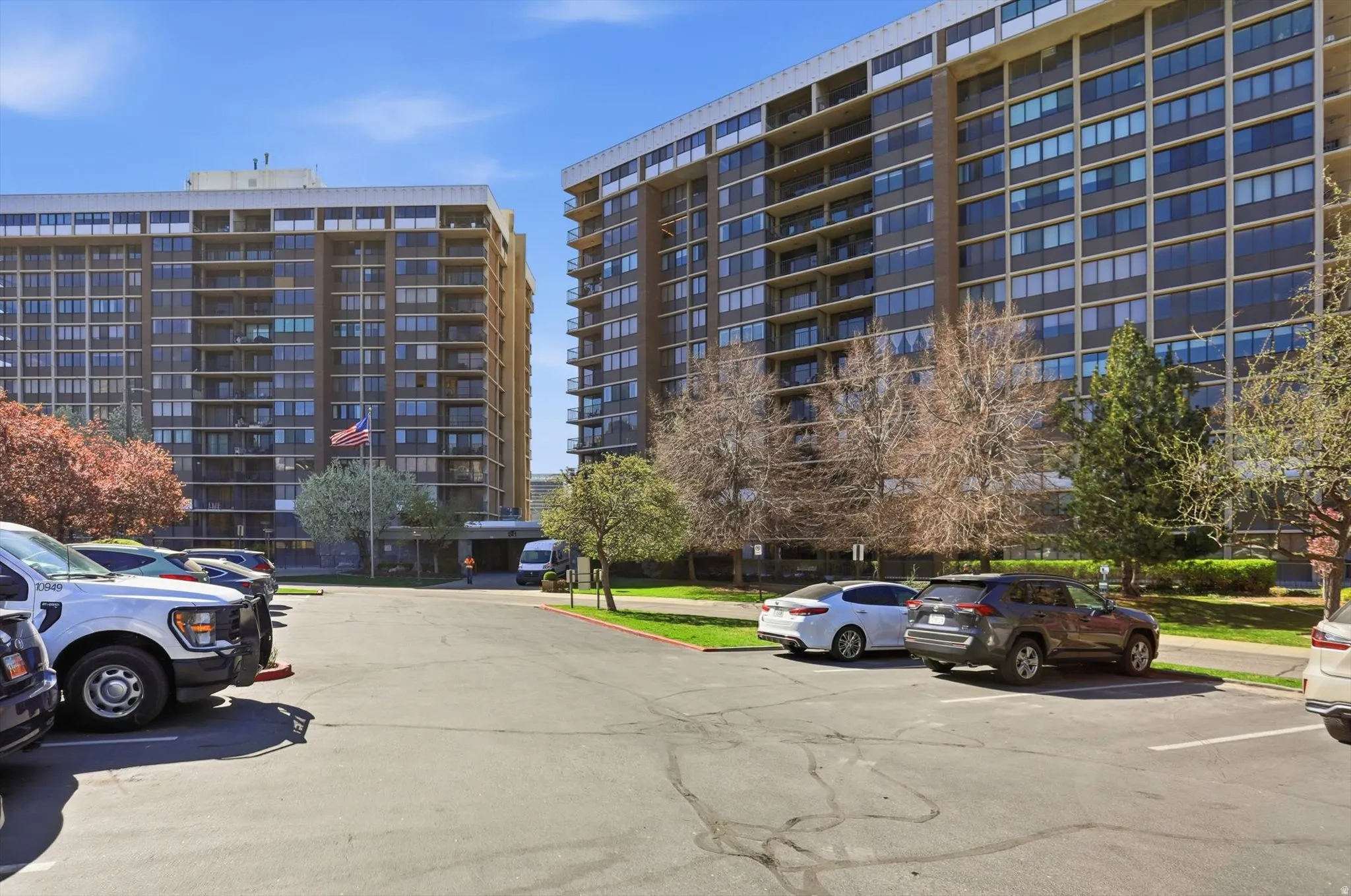 View of apartment building / complex with uncovered parking