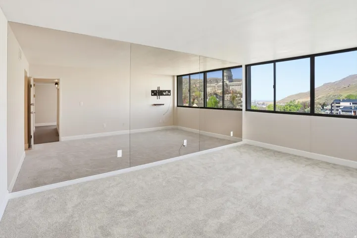 Unfurnished bedroom featuring carpet flooring and a mountain view