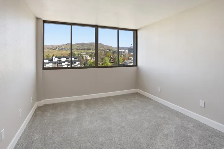 Spare room with a mountain view and light carpet