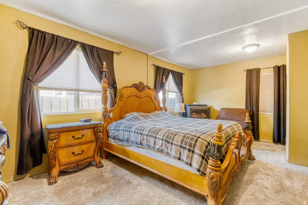 Bedroom featuring light carpet