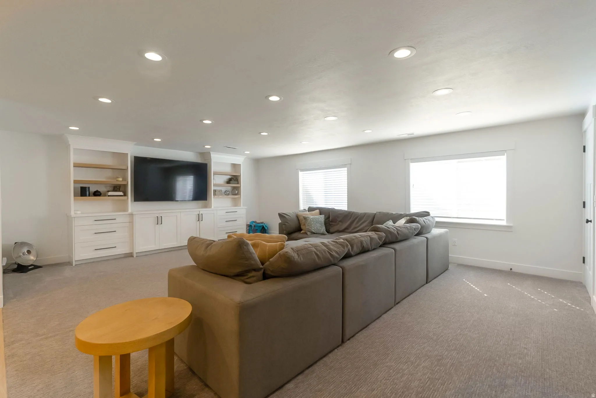 Downstairs family room with beautiful, built-in cabinets.
