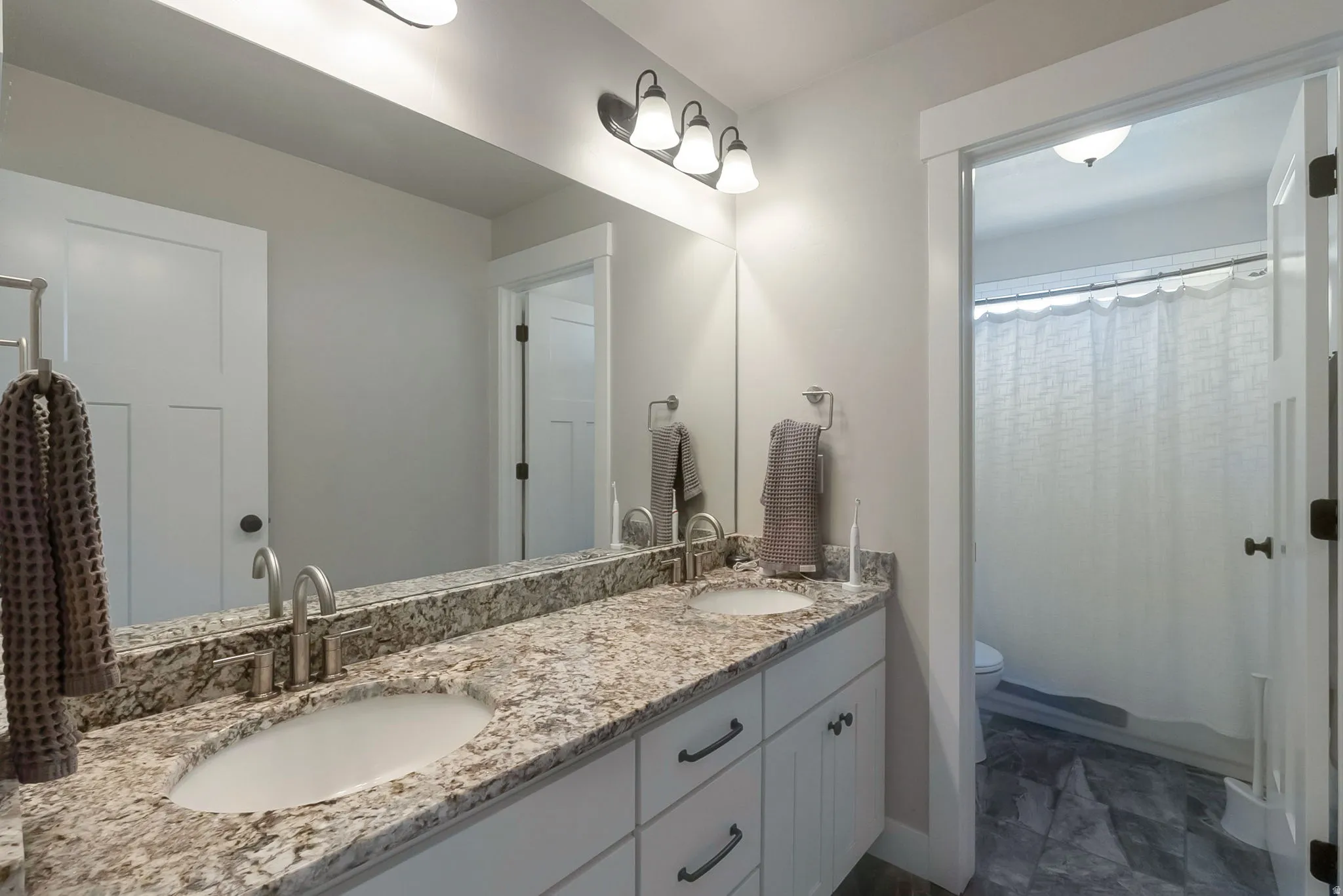 Upstairs bathroom with double vanity! A door separates the tub/toilet.