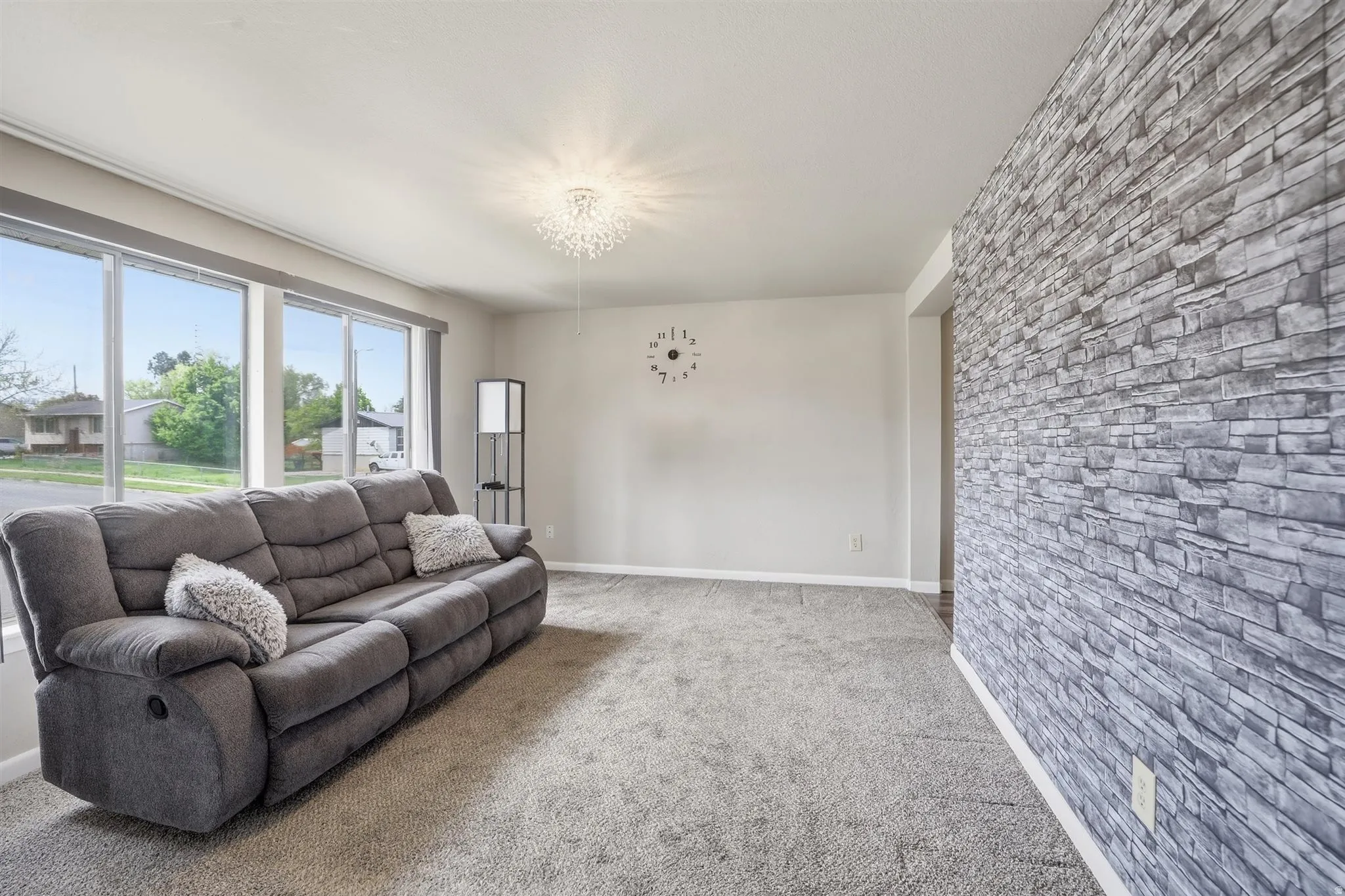 Living area featuring carpet and hanging lights