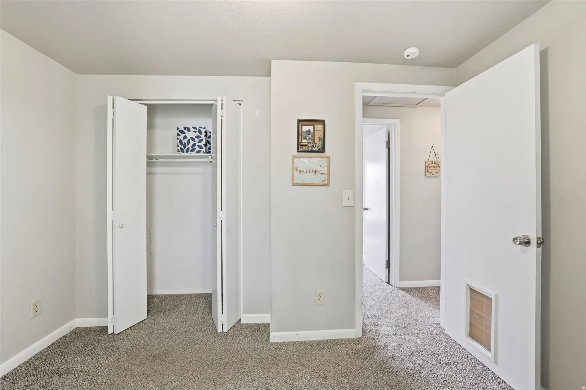 Unfurnished bedroom with light colored carpet and a closet