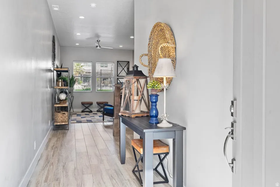Hallway featuring light wood-style floors and recessed lighting
