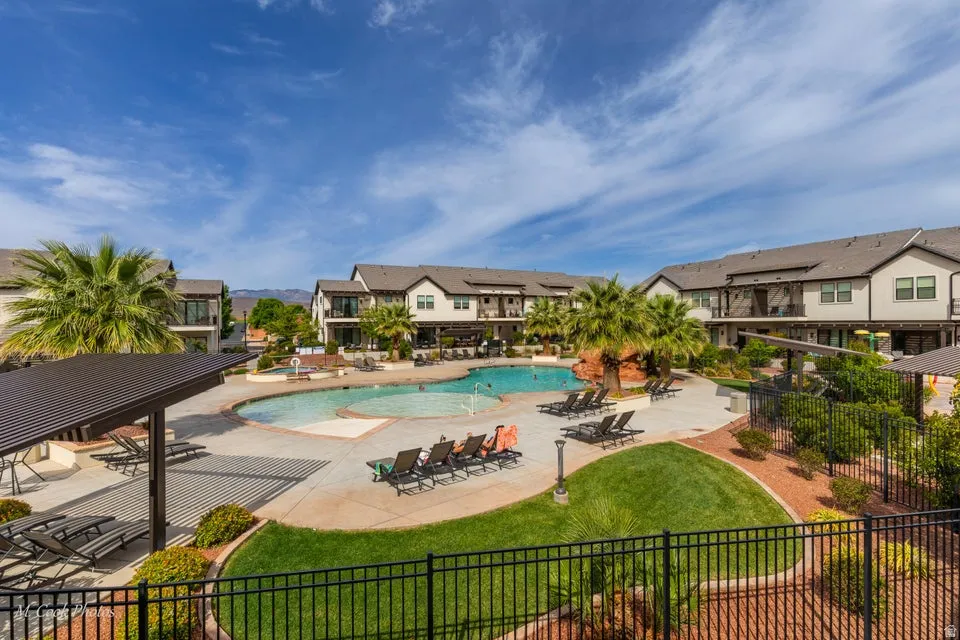 Community pool featuring a patio area and a residential view