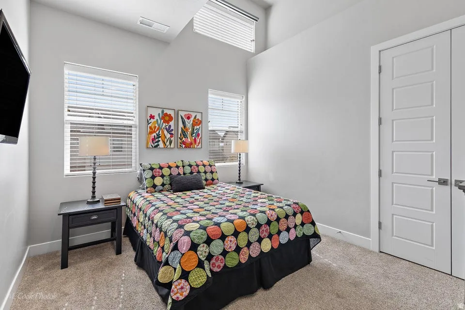 Bedroom with light colored carpet and baseboards