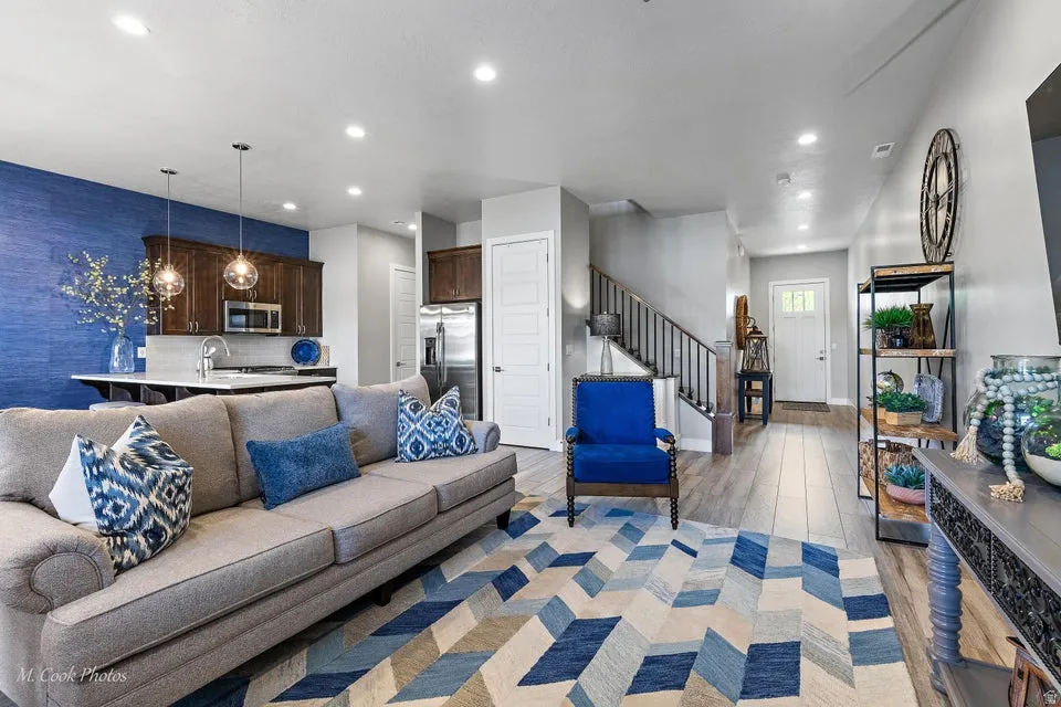 Living area with light wood-type flooring and recessed lighting
