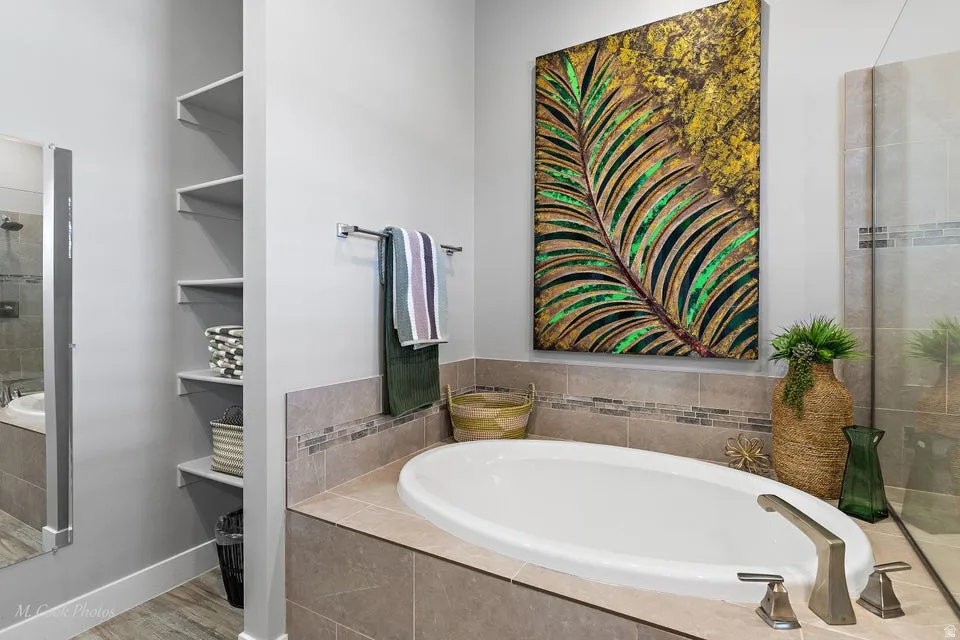 Full bathroom with a stall shower and a garden tub
