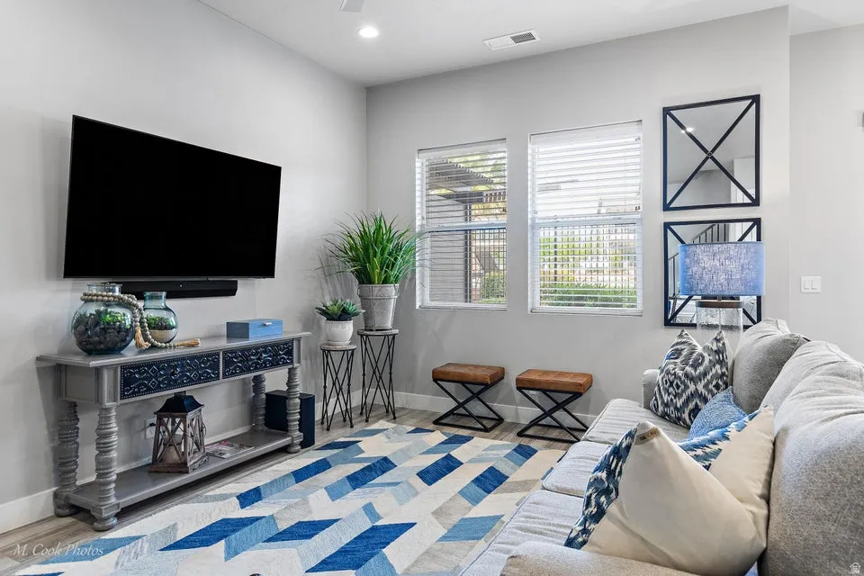 Living area featuring light wood-style floors and recessed lighting