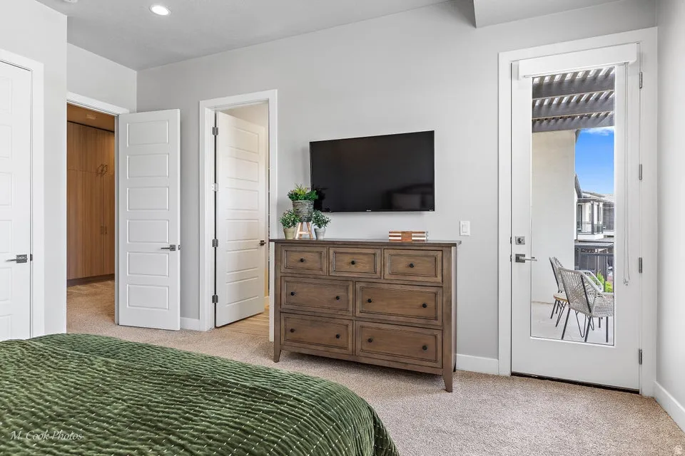 Bedroom with light carpet and access to exterior