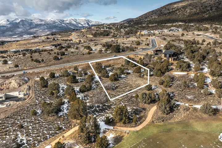 Aerial view of property's location with mountains, property parcel outlined, and rural landscape