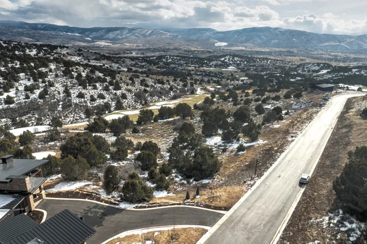 Aerial overview of property's location featuring a mountainous background