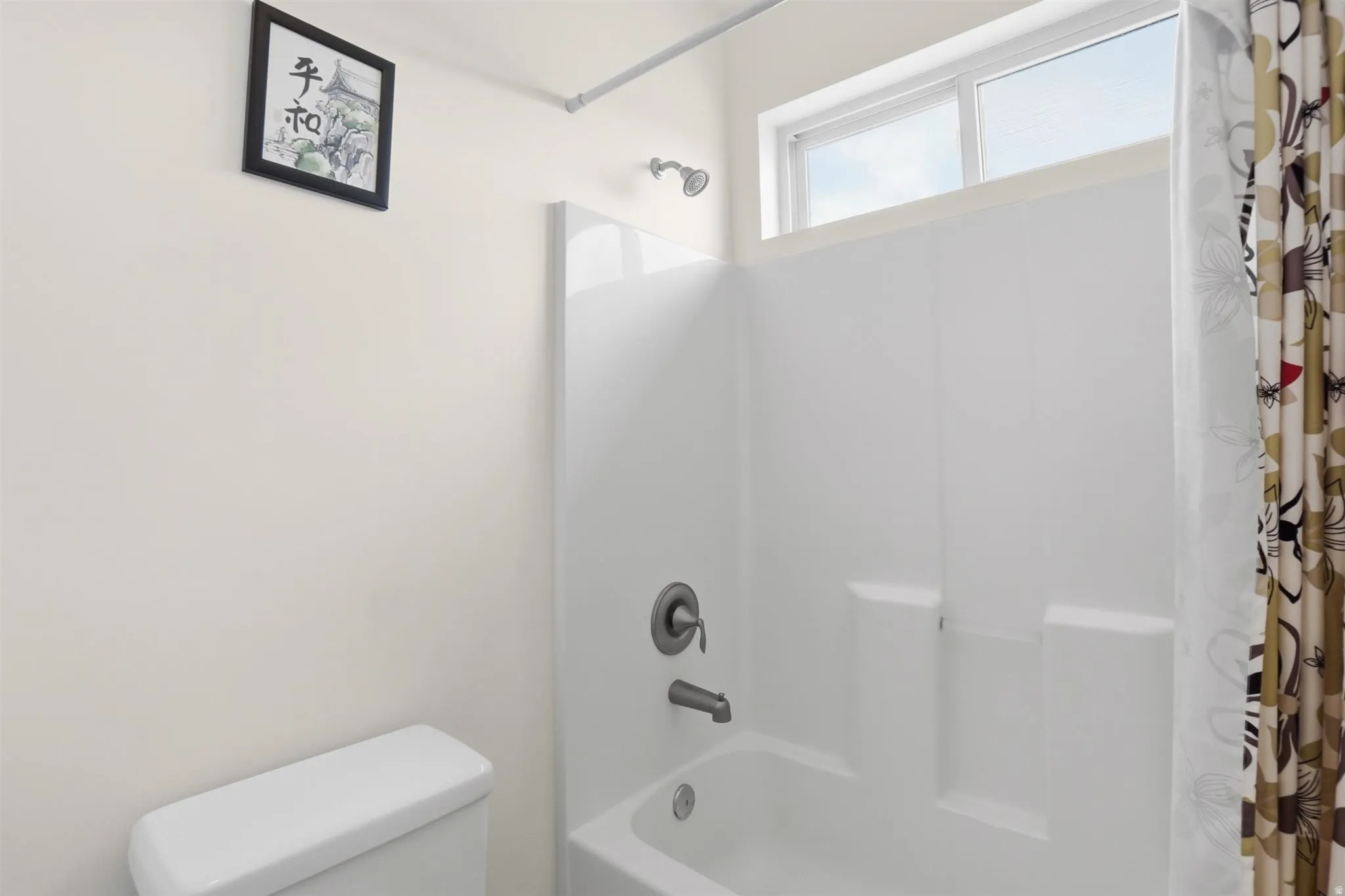 Bathroom with toilet and shower / tub combo