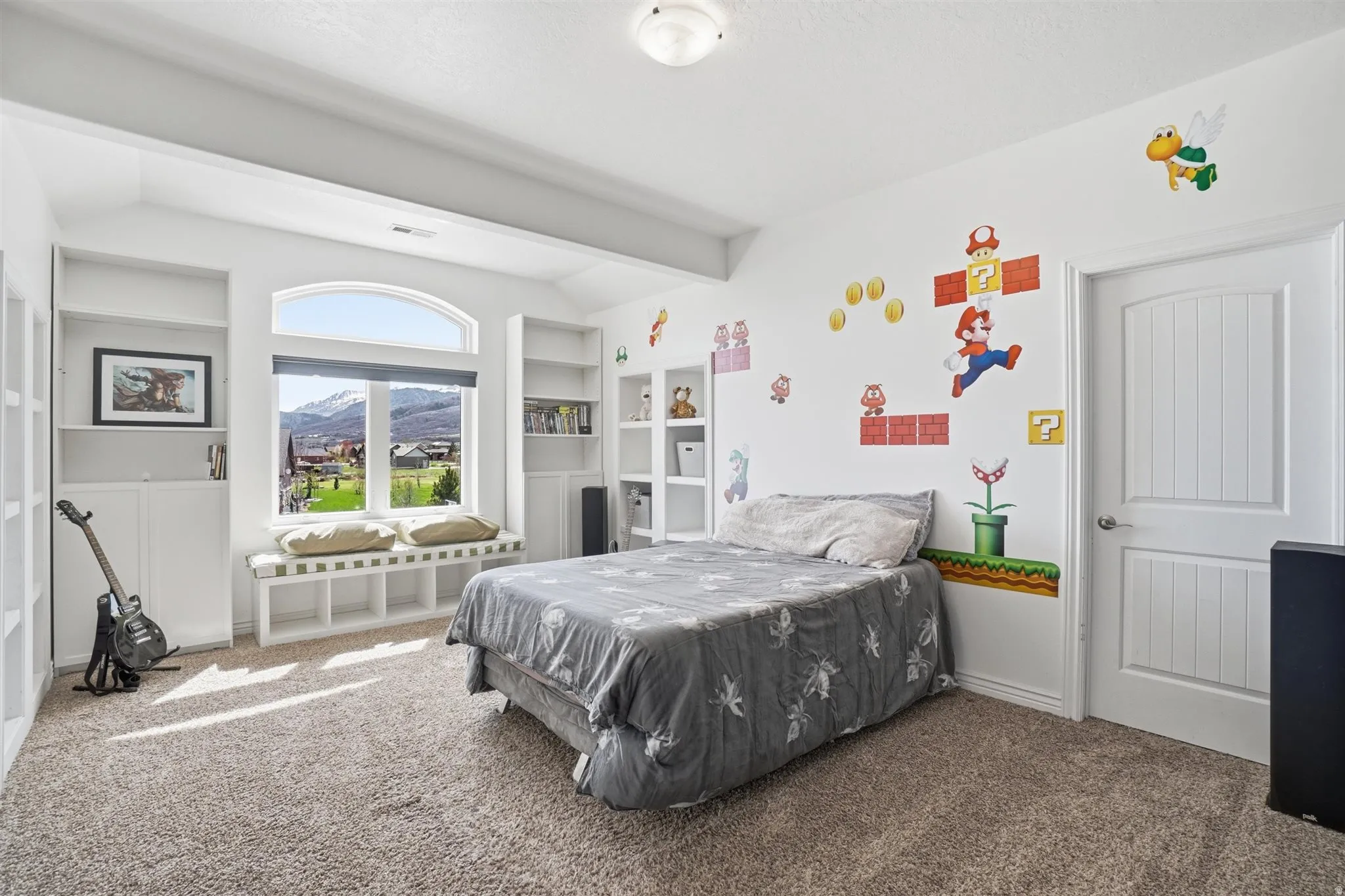 Bedroom with carpet floors, vaulted ceiling with beams, and a mountain view