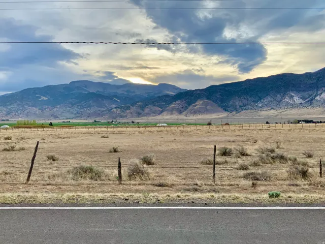 View of mountain backdrop featuring rural landscape