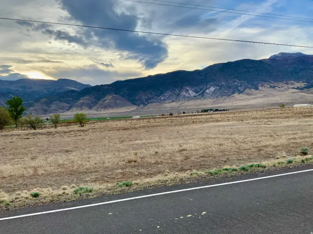 View of mountain backdrop with rural landscape
