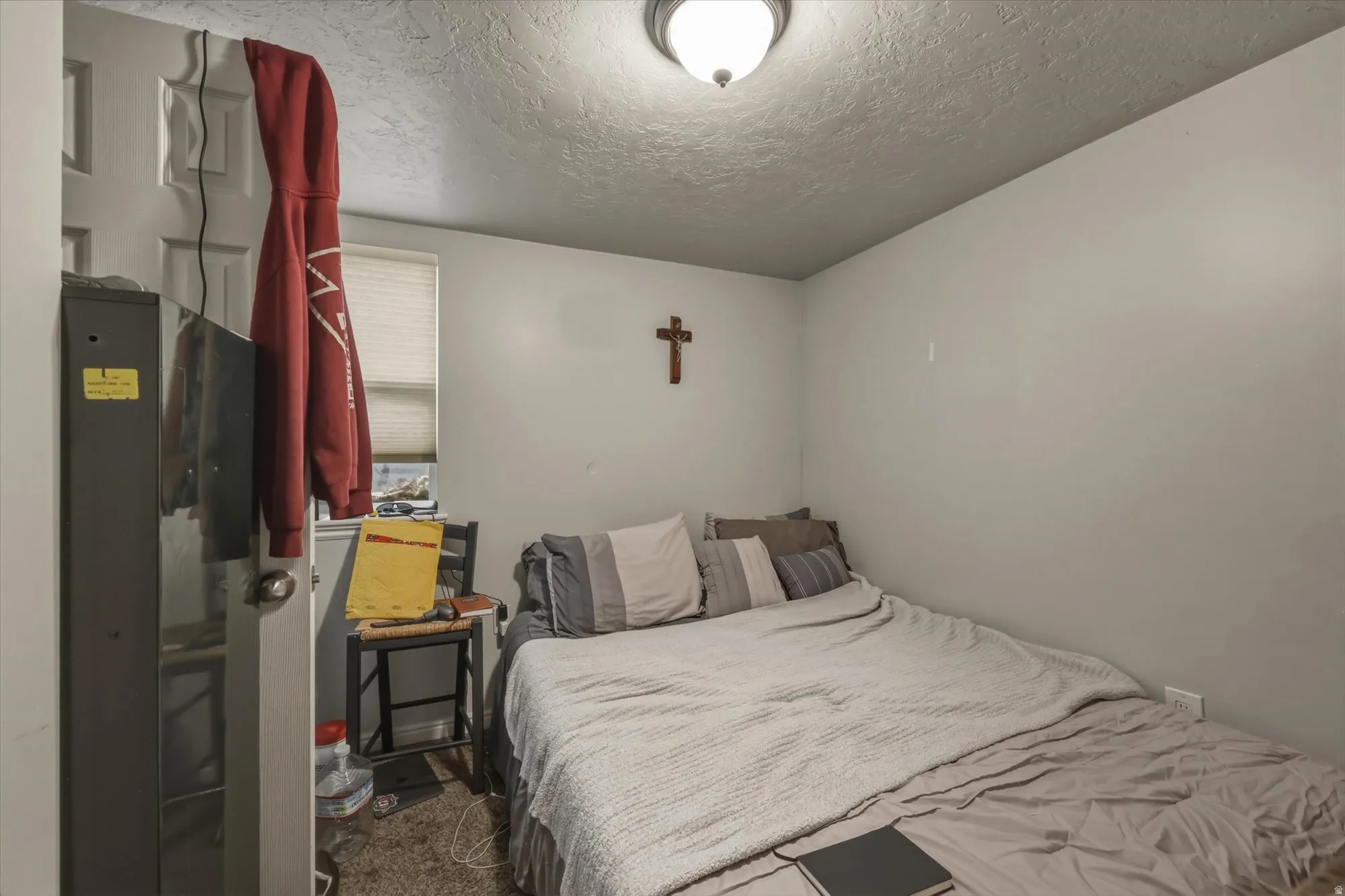 Bedroom with a textured ceiling