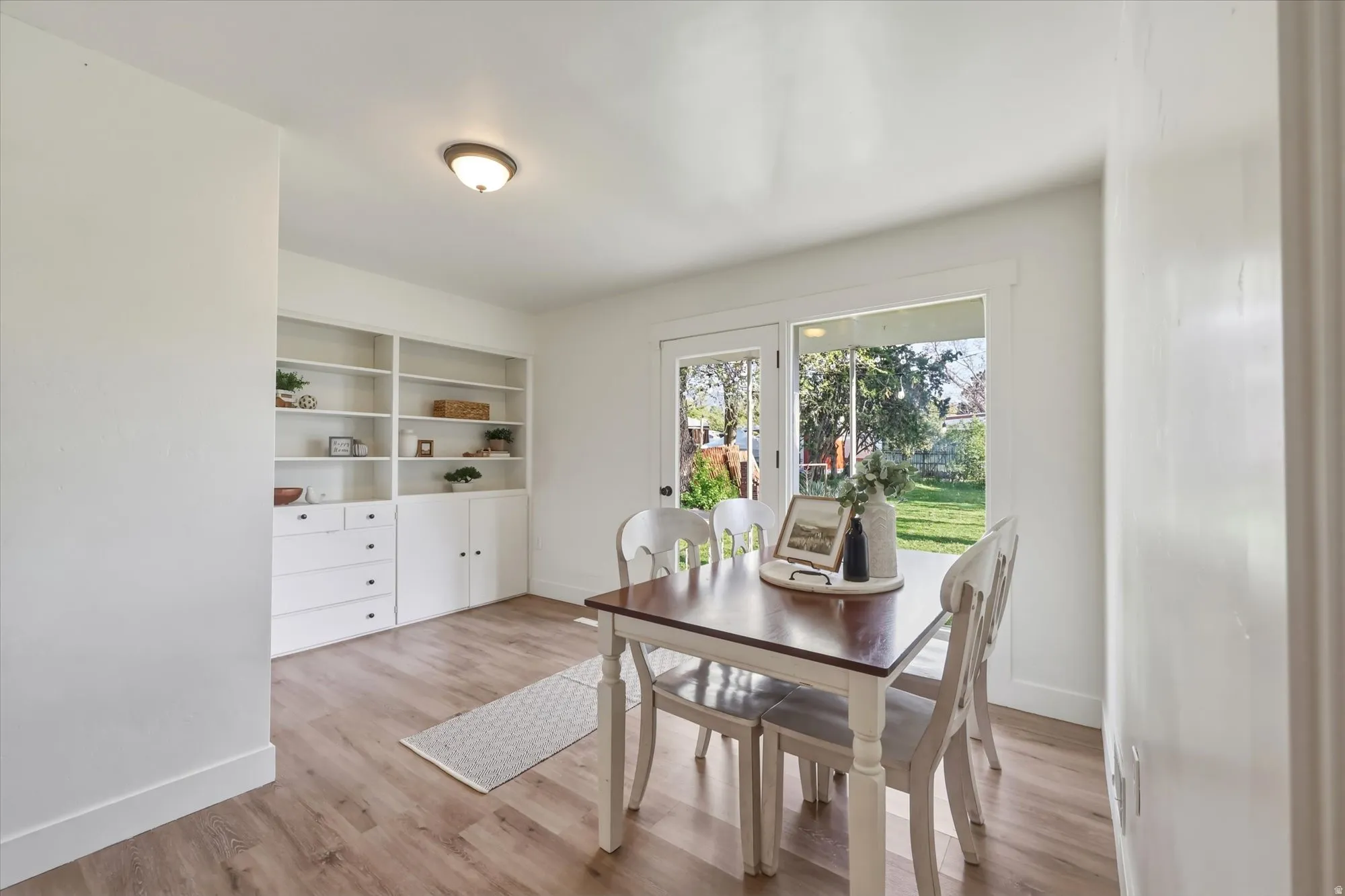 Dining area featuring light wood-style floors and baseboards