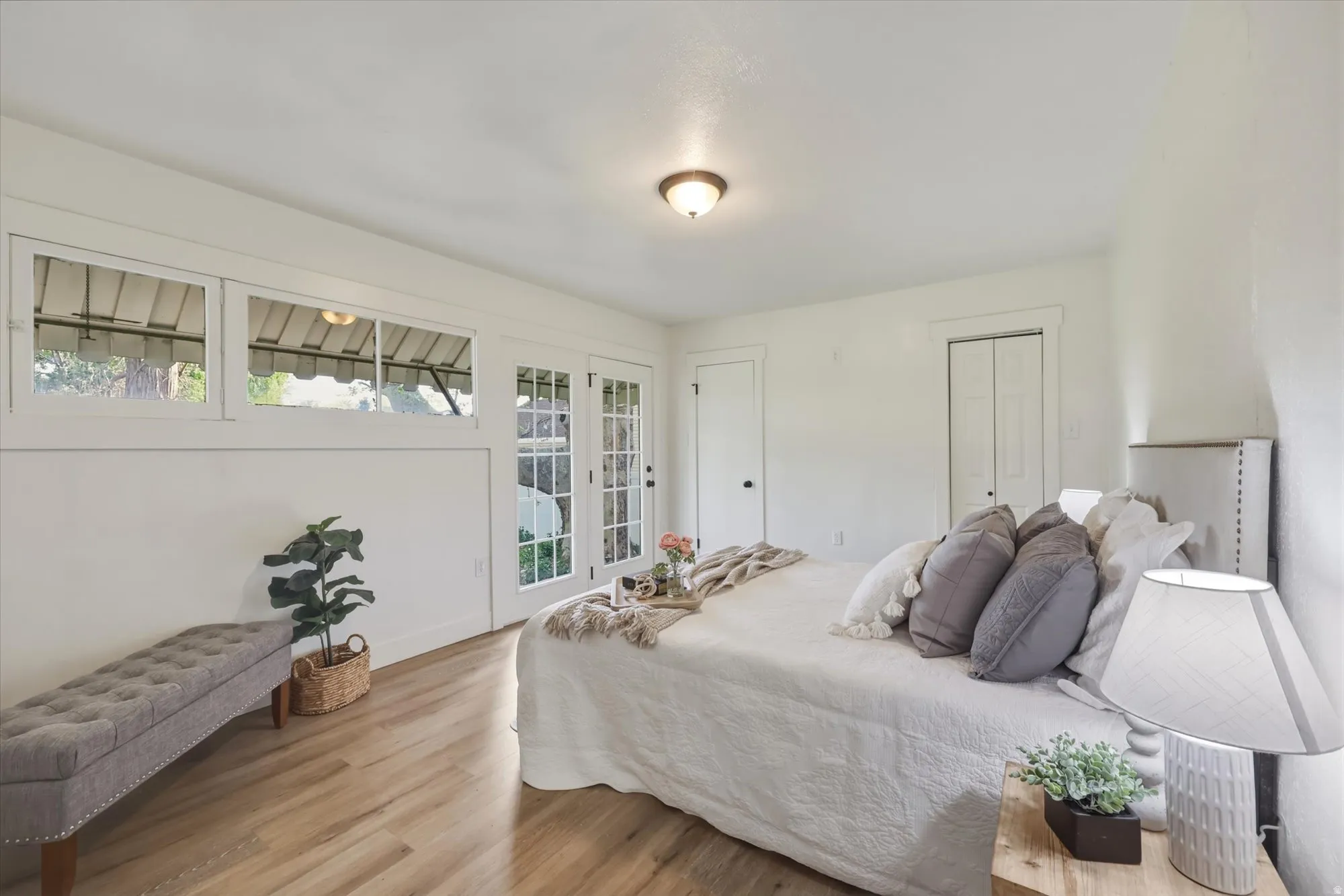 Bedroom featuring light wood-style flooring, a closet, and access to exterior