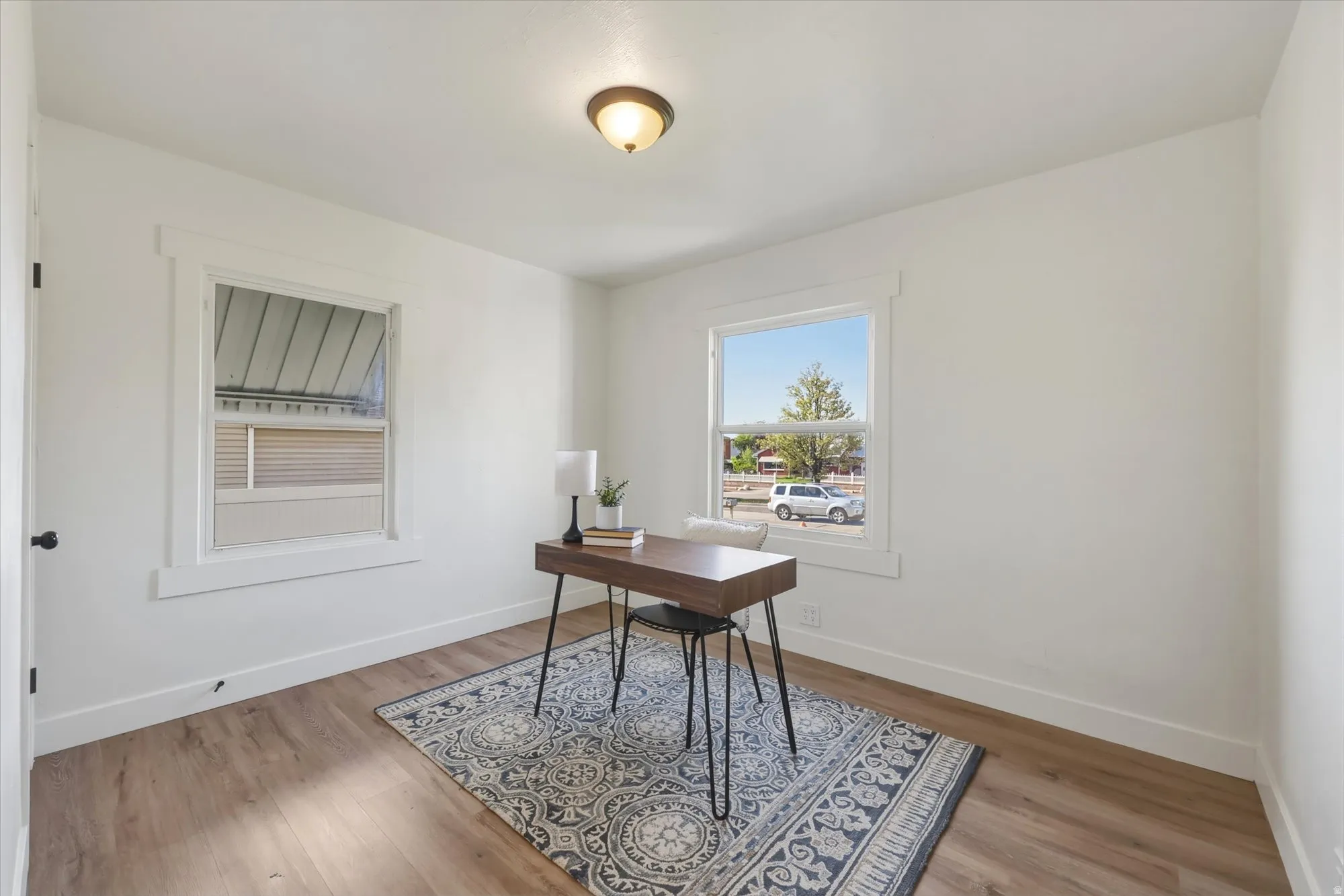 Office space featuring baseboards and light wood-type flooring
