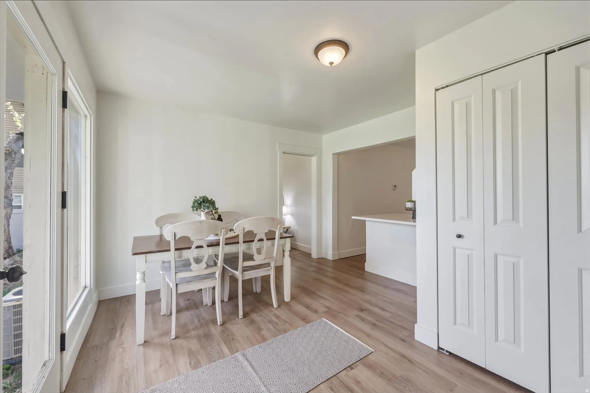 Dining room with light wood-type flooring and baseboards