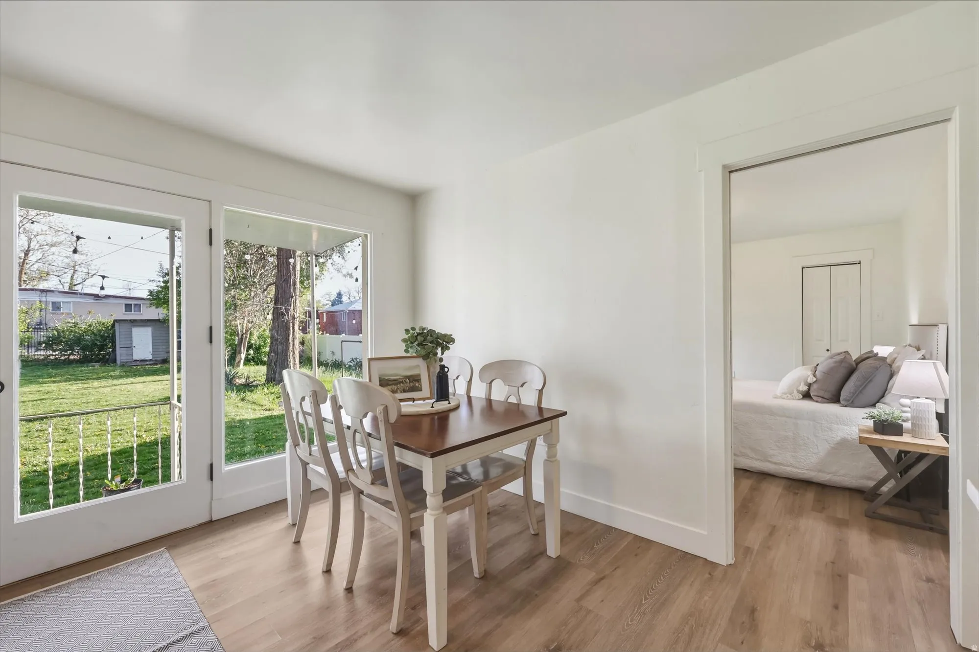 Dining space with light wood-style flooring and baseboards