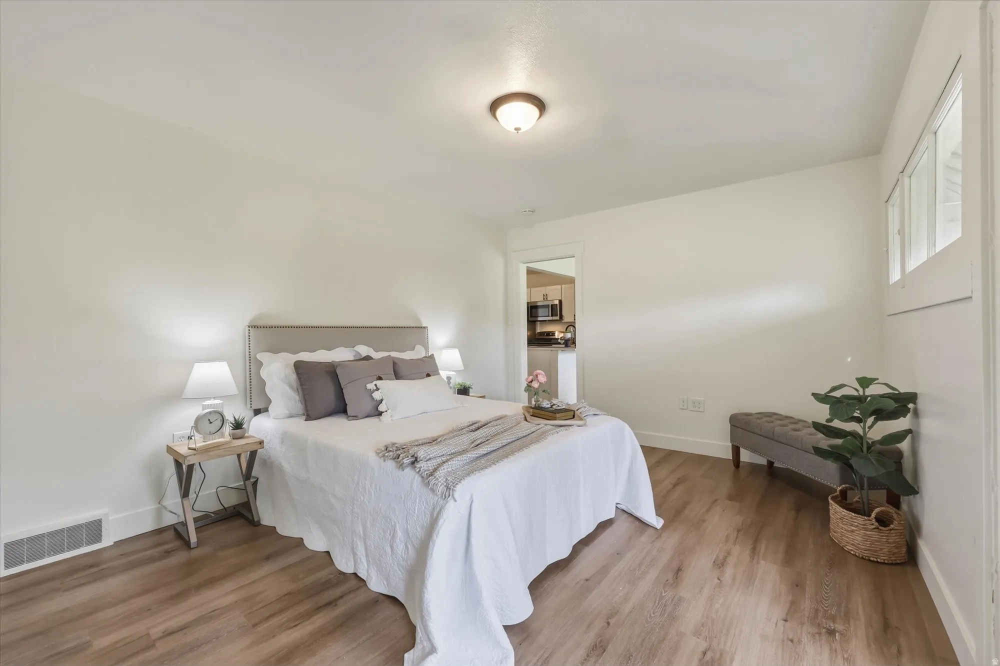 Bedroom featuring light wood-style floors and baseboards