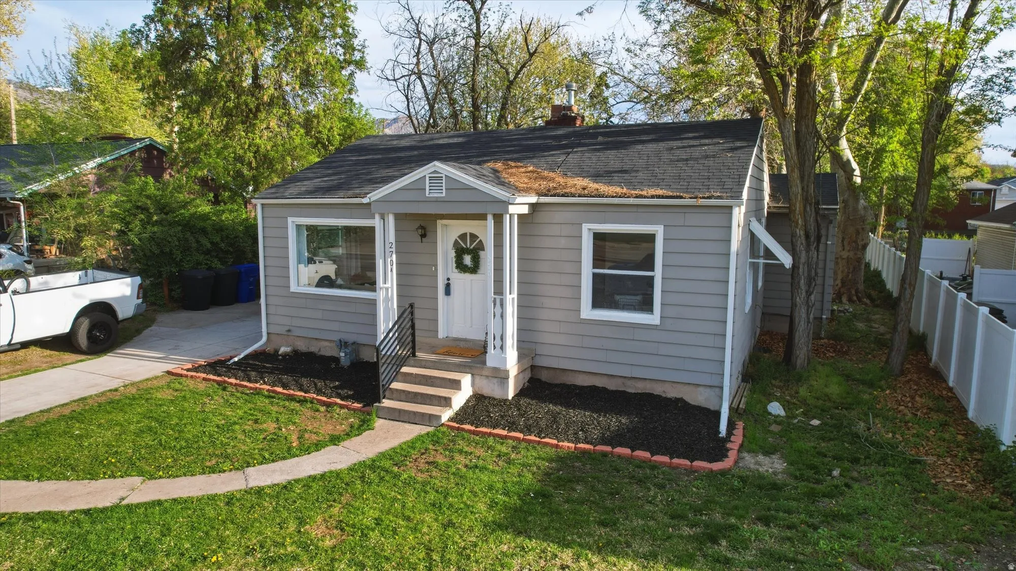 Bungalow-style house featuring a chimney and a shingled roof