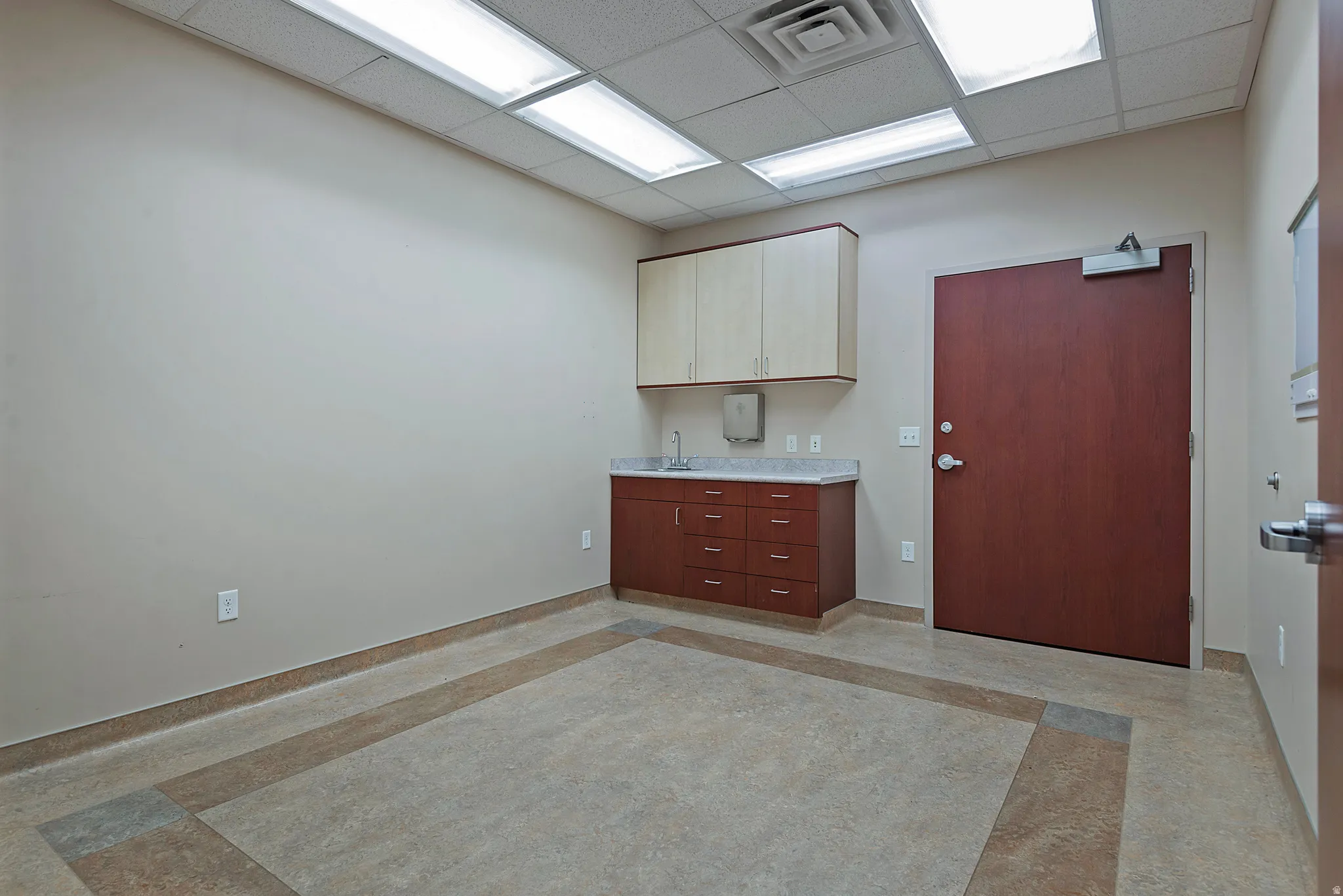 Kitchen featuring a drop ceiling and light countertops