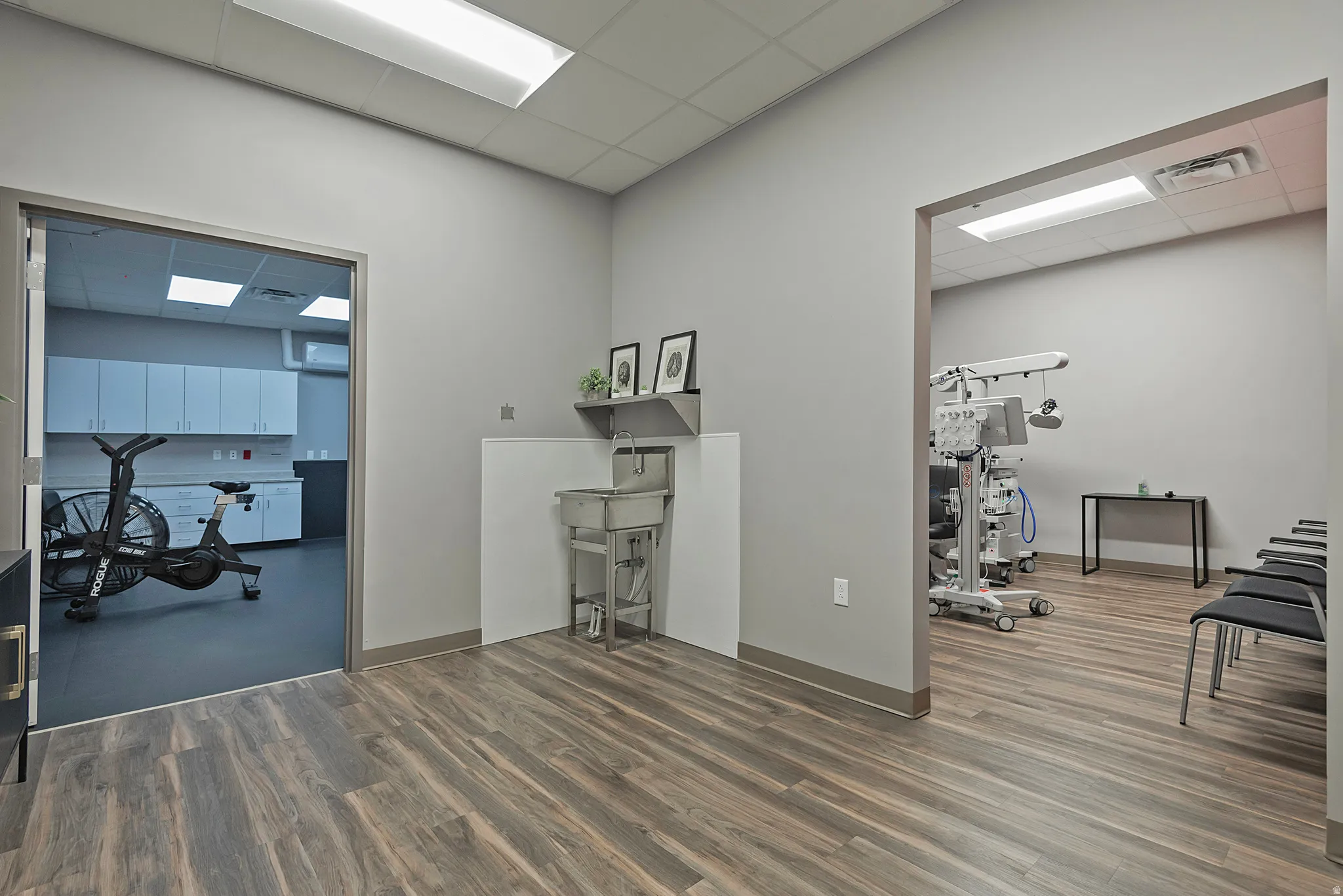 Home office with a drop ceiling and a wall unit AC