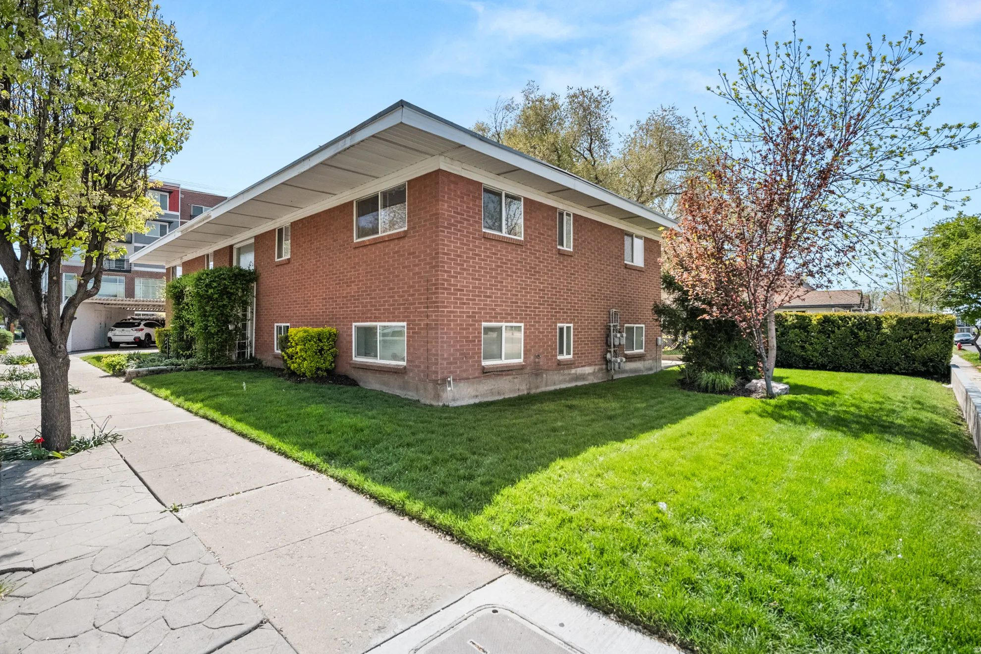 View of home's exterior with a yard and brick siding