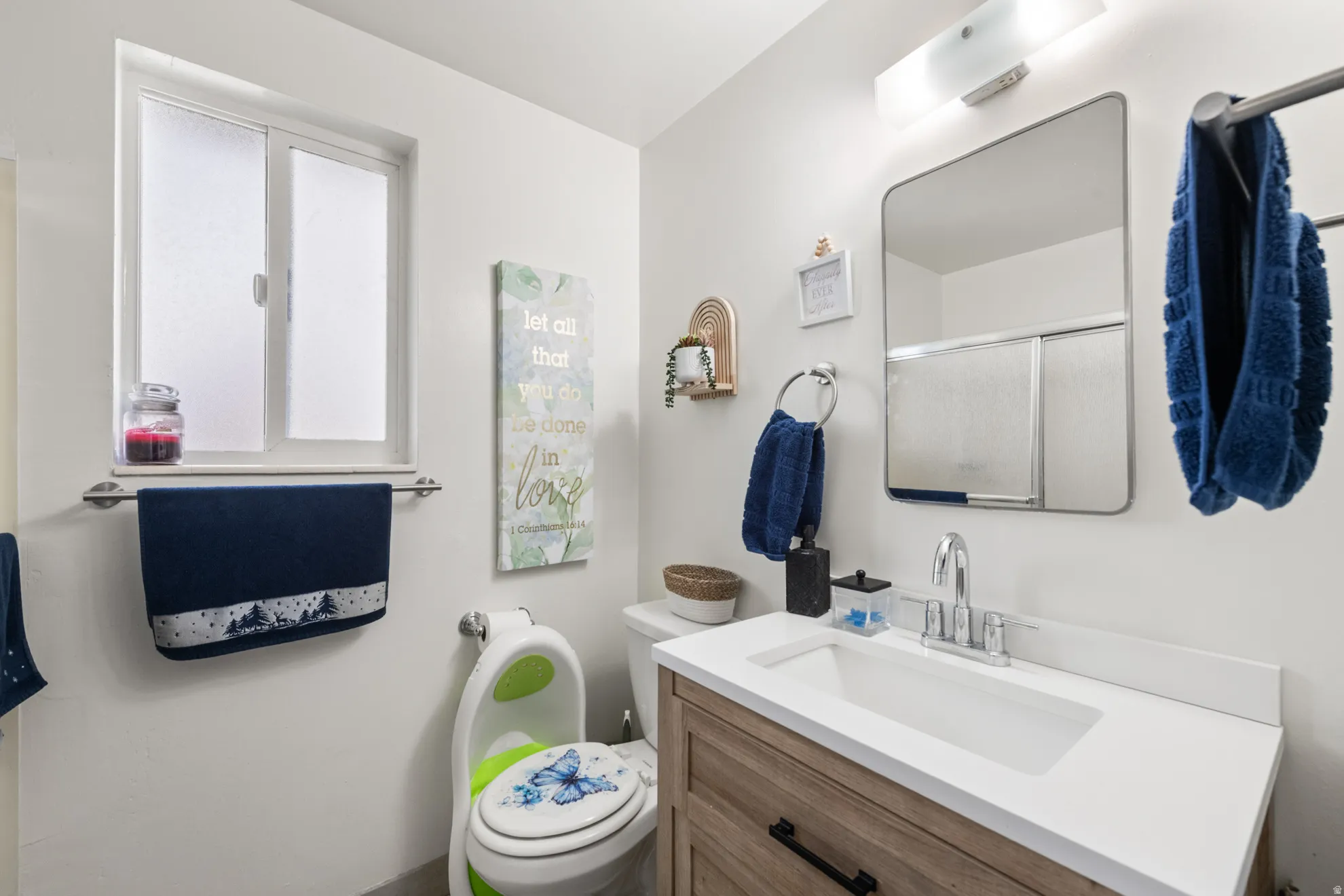 Full bath with a shower stall and vanity