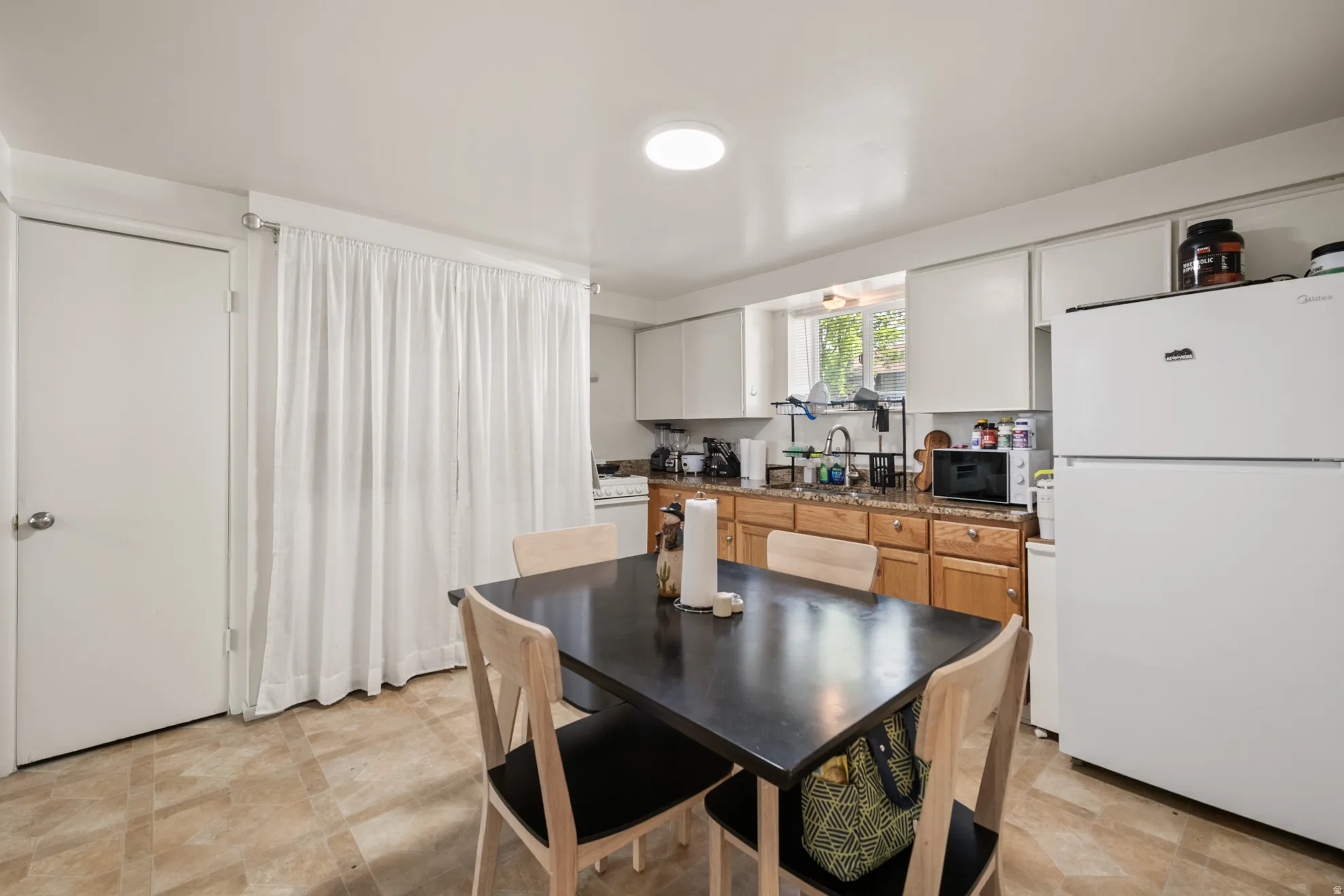 Dining space with stone finish flooring