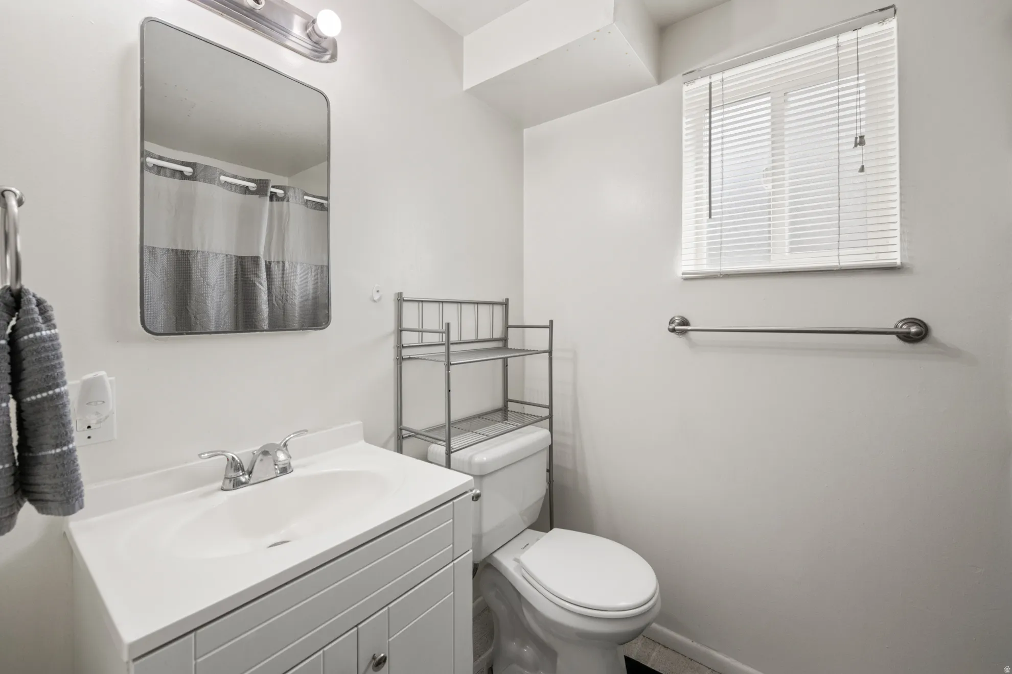 Bathroom featuring vanity and curtained shower