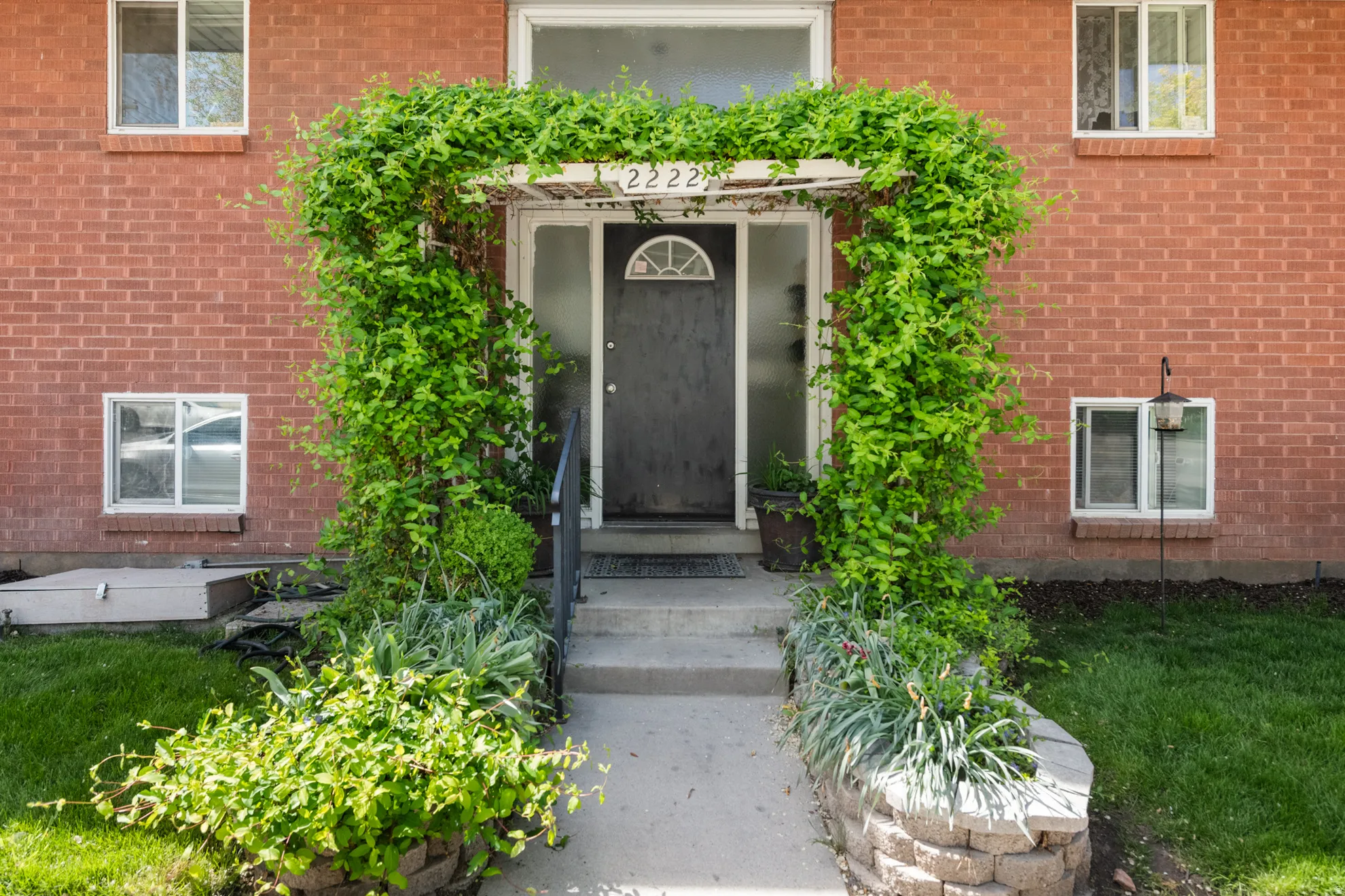 View of exterior entry featuring brick siding