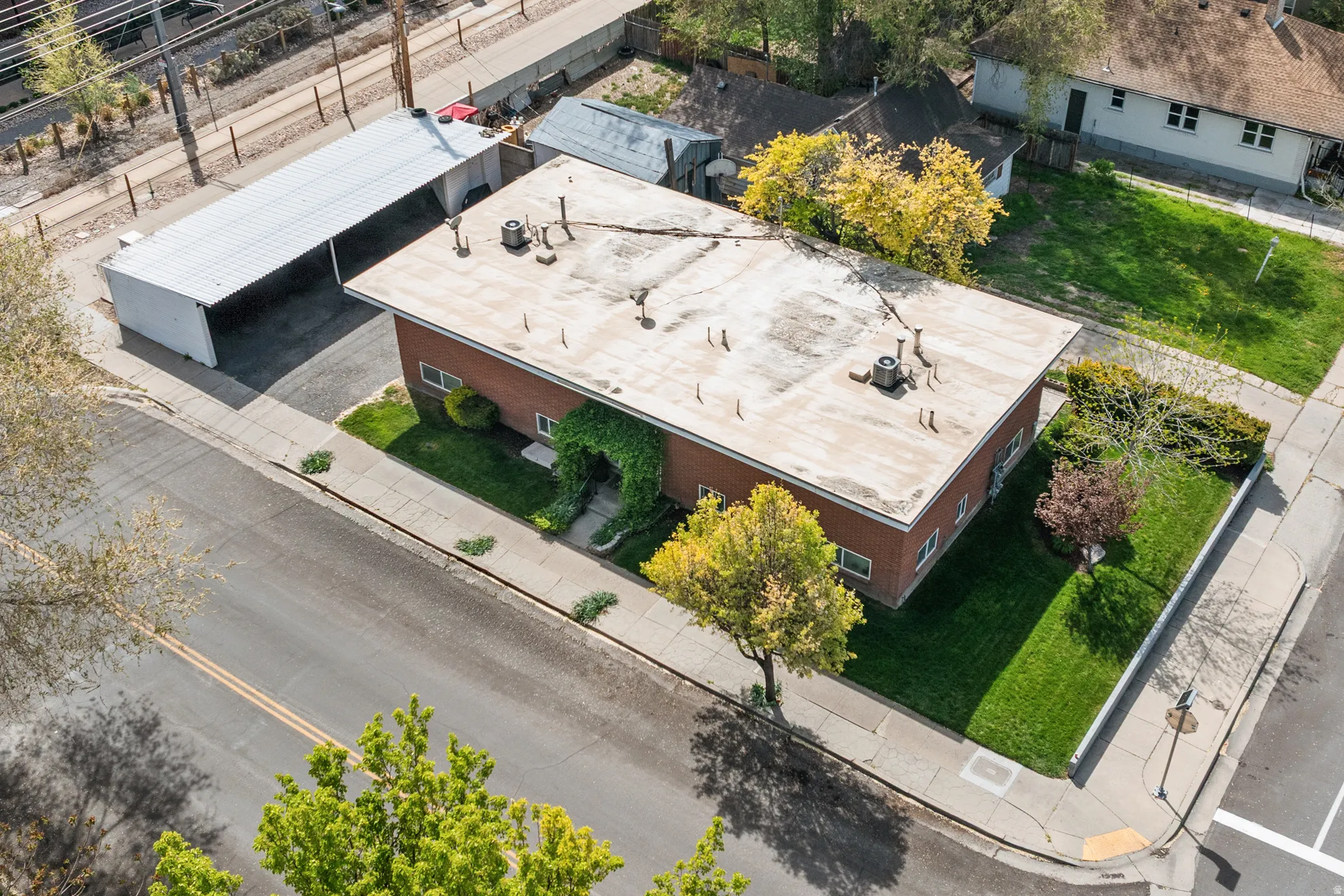 Bird's eye view showing well maintained fourplex and landscaping.