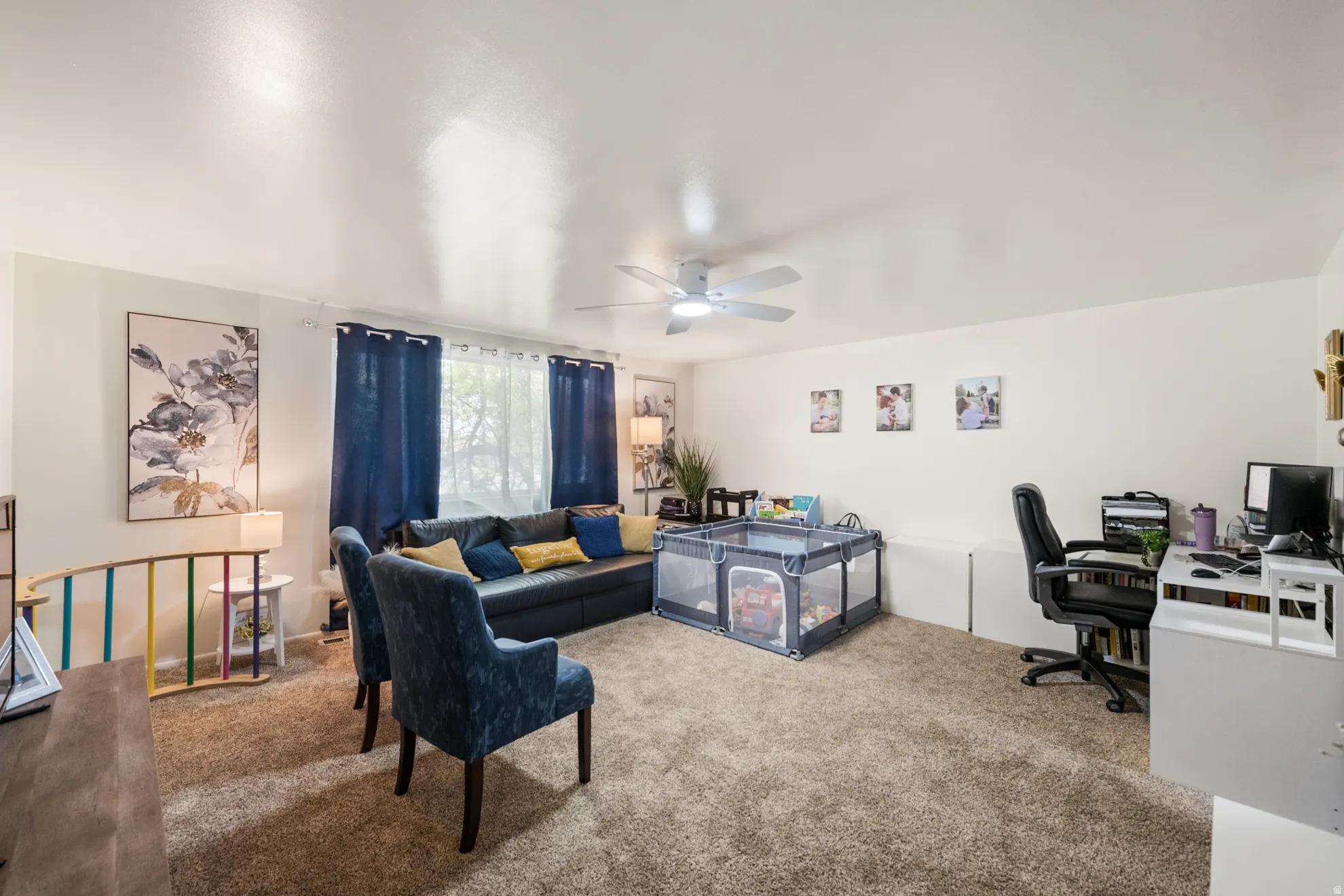 Home office featuring carpet flooring and a ceiling fan