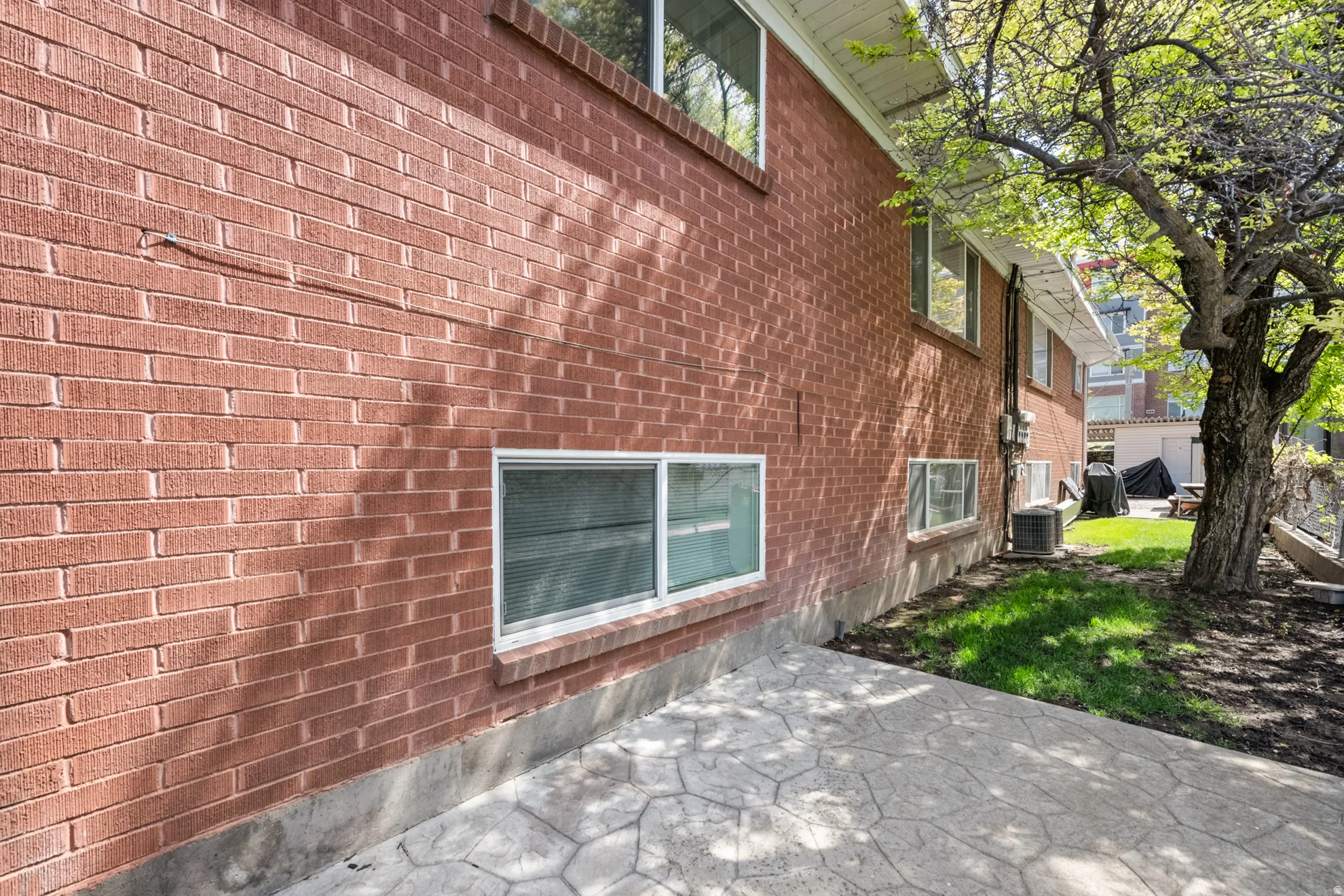 View of home's exterior with a patio area and brick siding