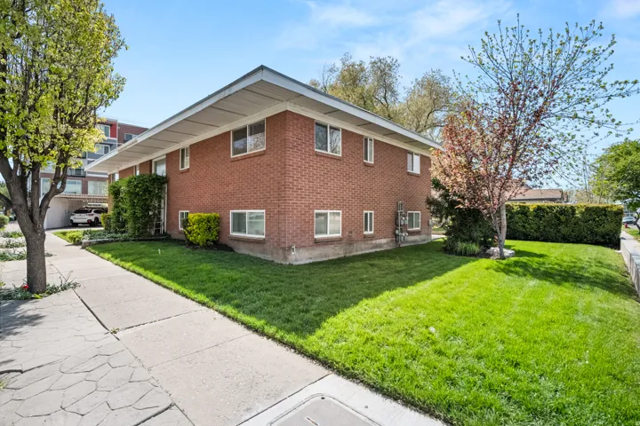 View of home's exterior with a yard and brick siding